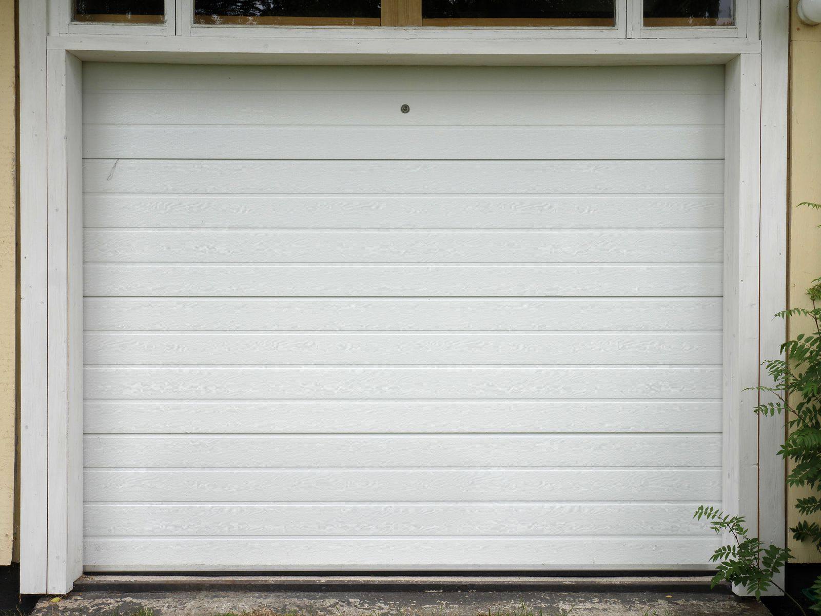 Clean white sectional garage door, close-up
